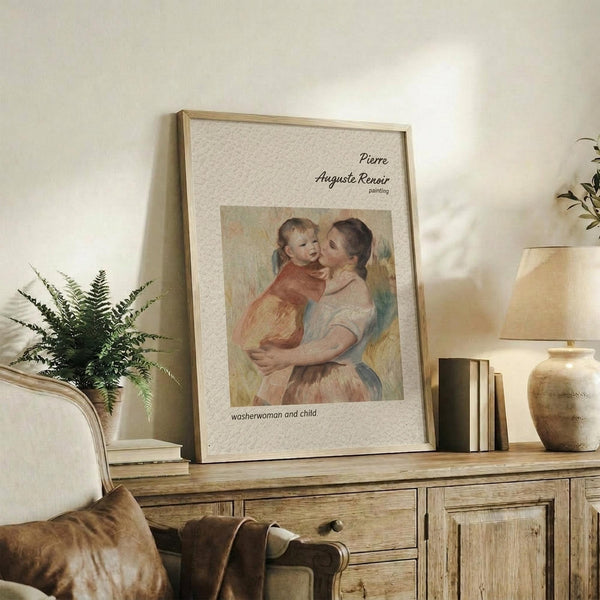 May include: Framed vintage-style art print featuring a tender mother and child painting in soft pastels, displayed on rustic wooden sideboard alongside fern plant, books, and ceramic vase in warm neutral living room setting with beige armchair and natural lighting.