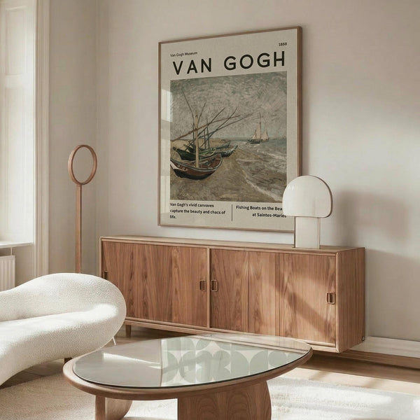 May include: Vintage Van Gogh museum poster featuring boats on a beach in muted earth tones, displayed above a mid-century modern walnut credenza in a minimalist living room. White sculptural chair and glass oval coffee table complete the scene with natural lighting creating soft shadows on cream walls.
