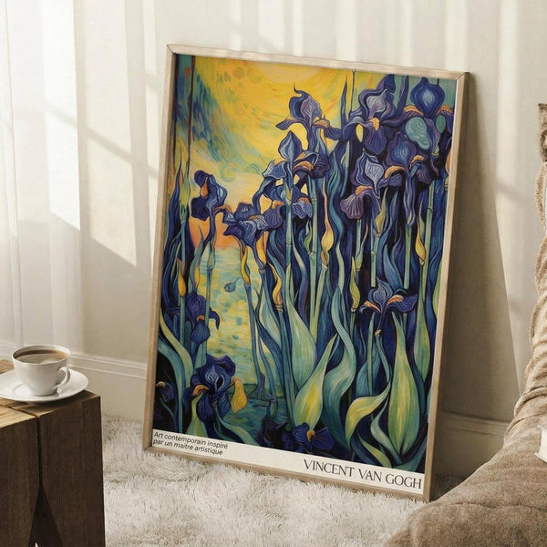 May include: Van Gogh's Irises reproduction poster in wooden frame, leaning against white wall in cozy room setting. Artwork features vibrant purple-blue iris flowers with flowing green stems against golden yellow swirled background. Poster has white border with artist name at bottom. Scene includes white coffee cup on wooden block, beige knit throw, and white textured rug on wooden floor with natural window light.