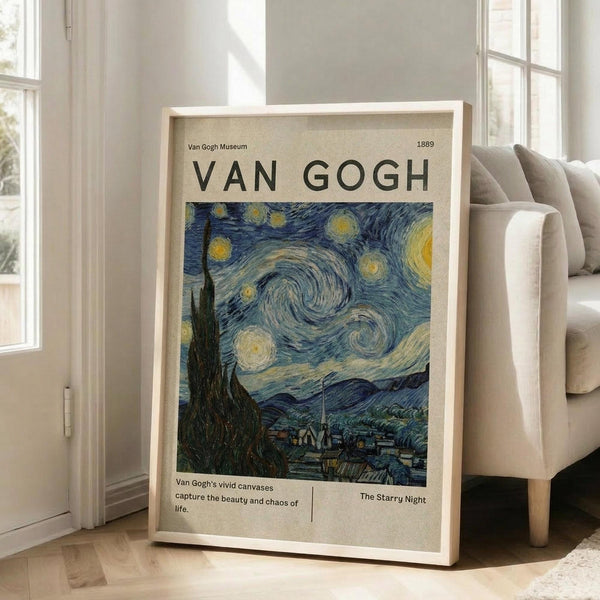 May include: Framed museum-style poster featuring Van Gogh's Starry Night painting with swirling blue sky, yellow stars, and dark cypress tree. The beige poster has "VAN GOGH" text at top and "Van Gogh Museum 1889" details. Light wooden frame leans against white wall next to beige upholstered chair in bright, minimalist living room with large windows and natural light casting shadows on hardwood floors.