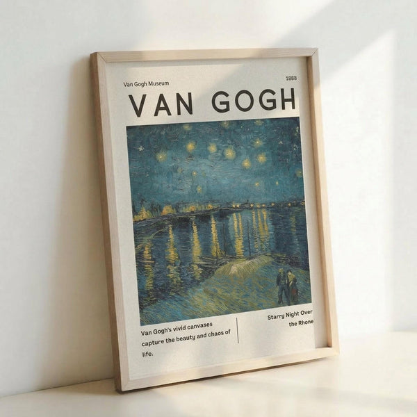 May include: Framed museum-style poster featuring Van Gogh's Starry Night Over the Rhone painting with swirling blue night sky, golden stars and lights reflecting on water, two figures in foreground. Light wood frame with white matting, leaning against white wall on light surface. Poster shows Van Gogh Museum branding and descriptive text below artwork.