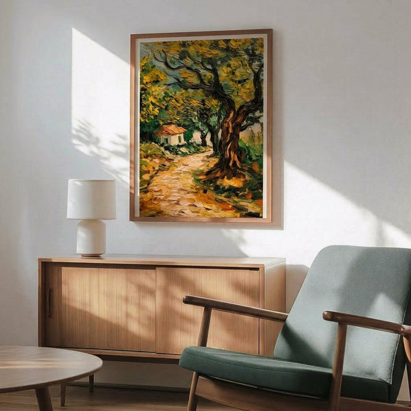 May include: Vincent van Gogh's olive trees painting print in thin wooden frame hanging on white wall above natural wood sideboard with white table lamp. Mint green mid-century armchair with wooden arms sits nearby. Artwork shows gnarled olive tree with golden-yellow foliage along winding path leading to small house, painted in van Gogh's characteristic swirling brushstroke style with vibrant yellows, greens, and earth tones. Warm sunlight streams across minimalist room.