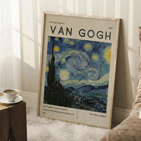 May include: Museum-style poster featuring Van Gogh's Starry Night painting with swirling blue sky, yellow stars, and dark cypress tree, displayed in light wood frame leaning against white wall corner. White coffee cup sits on wooden block nearby on textured cream rug. Poster shows beige background with black text and 1889 date.