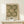 May include: Framed botanical poster featuring repeating chrysanthemum flowers in cream and sage green colors, displayed on light wood shelf against white wall. Small white gift box with twine and evergreen sprig sits in front of the natural wood frame.