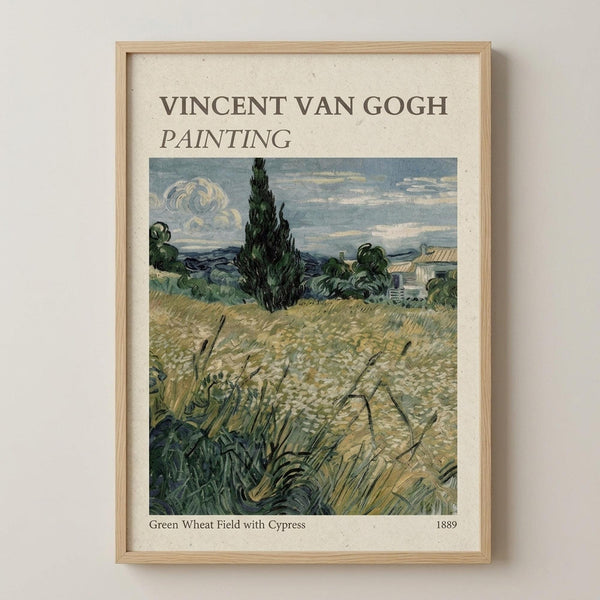 May include: Framed art print of Van Gogh's wheat field painting displayed on white wall. Print shows golden wheat field in foreground with tall dark cypress tree, green foliage, white building, and cloudy blue sky. Text reads "Vincent Van Gogh Painting" at top and "Green Wheat Field with Cypress 1889" at bottom. Natural wood frame on cream textured background in post-impressionist style with visible brushwork.