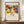 May include: Framed art print featuring Wassily Kandinsky's abstract expressionist artwork with bold red, yellow, blue and green shapes depicting stylized figures in motion. The poster shows "The Art Institute of Chicago (1913)" at top and "Klänge" and "Wassily Kandinsky" text below the colorful artwork. Wooden frame sits on mid-century modern walnut credenza alongside white ceramic vase and stacked books against cream wainscoting wall.
