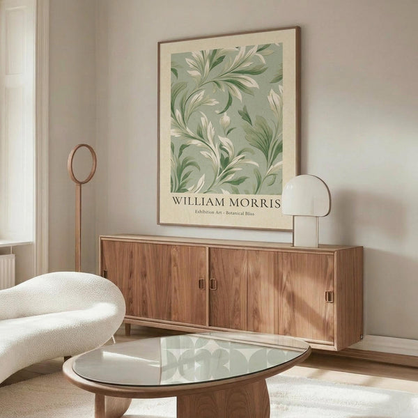 May include: Framed botanical art print with flowing green and cream leaves on sage background, displayed above mid-century walnut credenza in minimalist living room. White sculptural chair, glass oval coffee table, and modern brass floor lamp complete the neutral-toned interior scene.