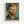Framed art print showing Van Gogh's self-portrait with reddish-brown hair and beard, piercing blue eyes, wearing a dark jacket with white collar. The portrait features his characteristic swirling brushstroke style with a blue-green spiral background. Text at bottom reads "Vincent van Gogh" and "self portrait." Light wood frame against white wall.