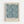 May include: Framed art print featuring an intricate blue floral pattern with marigold flowers and flowing botanical motifs on cream background, displayed in light wood frame against white wall. The design shows repeating ornate flowers with detailed petals and swirling leafy stems in vintage decorative style.