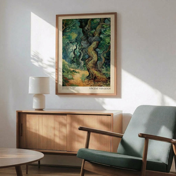 May include: Framed Van Gogh-style poster showing swirling cypress trees in rich greens and blues, displayed above a mid-century modern wooden credenza with white ceramic lamp. Light green upholstered armchair with wooden frame sits nearby on hardwood floors. Dramatic sunlight creates angular shadows across white wall in minimalist living room setting.