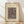 May include: Framed abstract art print with geometric shapes, lines, and symbols in muted brown tones on cream background, displayed in light wood frame against white wall on wooden floor with soft natural lighting and shadows