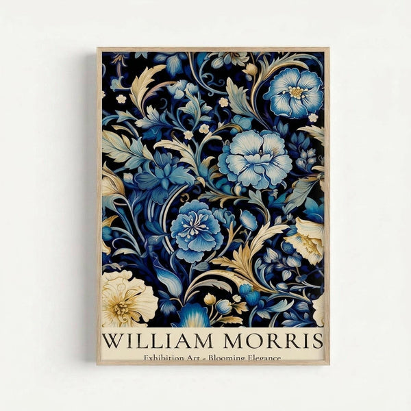Framed art print featuring an intricate floral pattern with blue peonies, cream flowers, and golden scrolling foliage on a deep navy background. The botanical design shows layered petals with detailed shading and ornate curving stems. Text reading "WILLIAM MORRIS Exhibition Art - Blooming Elegance" appears at the bottom. The print is displayed in a thin natural wood frame against a light gray wall.