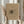 May include: Person in cream ruffled blouse holding framed abstract artwork with dark gestural marks on beige paper, standing near window with dried wheat stems, neutral toned room setting