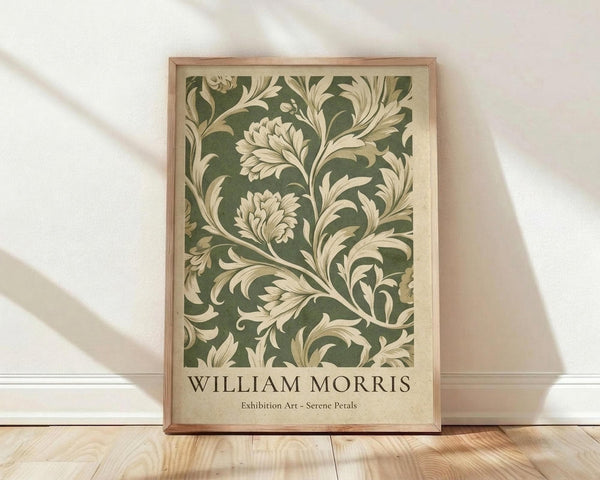 May include: Framed botanical art print leaning against white wall on light wood floor with soft natural lighting. Features vintage-style green and cream floral pattern with ornate leaves and blooms in decorative swirling design. Thin natural wood frame surrounds the artwork with cream border and dark text at bottom.