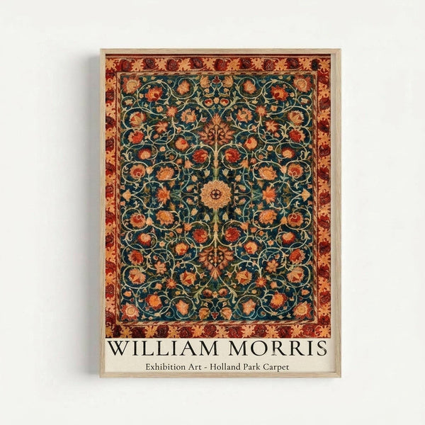 Ornate carpet design poster featuring intricate floral patterns on a dark teal background with orange and rust colored flowers, surrounded by a decorative border in warm earth tones. The artwork is displayed in a light wood frame against a white wall, showing detailed Victorian-era textile motifs with symmetrical botanical elements and scrolling vines throughout the composition.