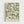 May include: Framed botanical art print hanging on white wall, featuring flowing green leaves and foliage in vintage Arts and Crafts style against cream background, displayed in light wood frame with "William Morris" and "Exhibition Art - Meadow Harmony" text at bottom