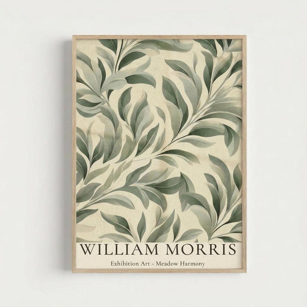 May include: Framed botanical art print hanging on white wall, featuring flowing green leaves and foliage in vintage Arts and Crafts style against cream background, displayed in light wood frame with "William Morris" and "Exhibition Art - Meadow Harmony" text at bottom