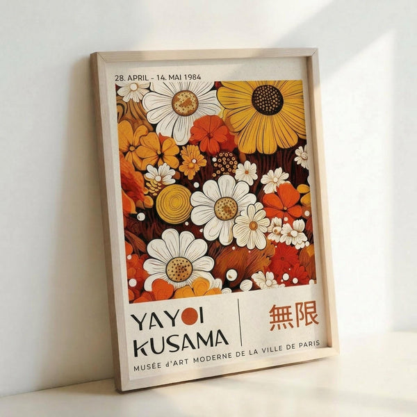 Vintage exhibition poster in warm autumn tones featuring stylized flowers including daisies, sunflowers, and botanical motifs in orange, yellow, white, and brown colors. The artwork displays "YAYOI KUSAMA" and Japanese characters with "MUSÉE D'ART MODERNE DE LA VILLE DE PARIS" text below, dated "28. APRIL - 14. MAI 1984" at top. Displayed in light wooden frame leaning against white wall.
