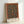 May include: Framed poster print featuring an ornate Victorian carpet design with intricate floral patterns in deep teal blue center and warm rust orange border. The detailed botanical motifs show swirling vines, blooms, and medallions in rich jewel tones. Light wood frame displayed against white wall, casting subtle shadows. The artwork showcases traditional decorative arts with symmetrical composition and elaborate ornamental details.