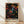 May include: Framed poster with vibrant abstract dot art on black background, featuring swirling patterns of colorful circles in orange, pink, blue, yellow, and green. Text reads "YAYOI KUSAMA" and "TOKYO" in bold letters below the psychedelic dotted design. Natural wood frame leaning against white wall on light wooden floor with soft shadows.