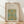 May include: Framed botanical poster with ornate floral pattern in turquoise, golden yellow, and green tones, displayed against white wall on light wood floor. Natural wood frame contains vintage-style decorative design with intricate vine motifs and symmetrical flower arrangements on cream background.