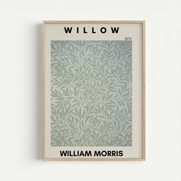 May include: Framed botanical art print displaying intricate green willow leaf pattern on cream background, mounted in light wood frame with white matting against neutral wall. Features flowing, symmetrical foliage design in soft sage and pale green tones with "WILLOW" text above and "WILLIAM MORRIS" below the artwork, plus "1874" date marking.