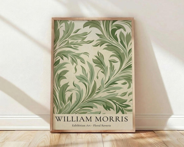 May include: Framed poster with flowing green botanical pattern featuring swirling acanthus leaves and organic flourishes on cream background, displayed in light wooden frame against white textured wall with natural sunlight shadows, positioned on light wood floor