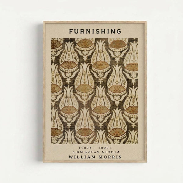 Framed vintage botanical wallpaper design poster featuring ornate brown and cream repeating pattern with decorative urns and foliage. The print displays "FURNISHING" at top, dates "1834-1896", "BIRMINGHAM MUSEUM", and "WILLIAM MORRIS" at bottom. Natural wood frame against white wall background with subtle shadow.
