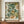 May include: Framed botanical art print featuring lush floral design with cream peonies, green foliage, and orange berries in William Morris decorative style, displayed on wooden sideboard beside white ceramic vase and stacked books against cream wainscoted wall