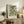 May include: Framed botanical art print featuring William Morris-inspired floral design with cream flowers, green foliage, and coral accents, displayed on rustic wooden sideboard alongside fern plant, books, ceramic vase, and table lamp in neutral-toned living room setting