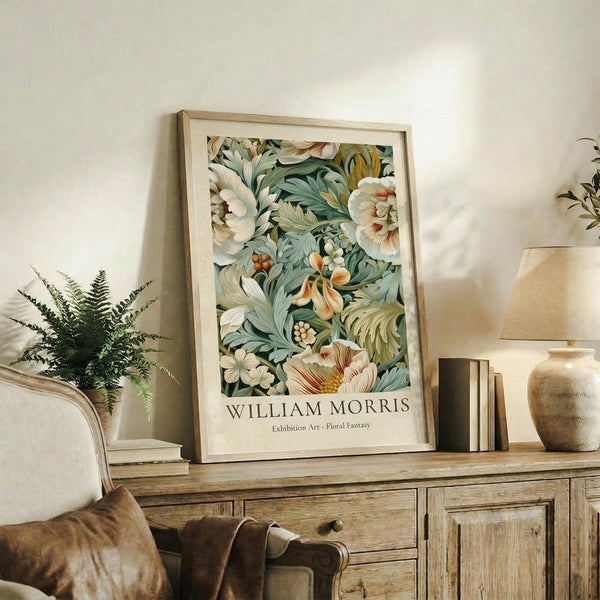 May include: Framed botanical art print featuring William Morris-inspired floral design with cream flowers, green foliage, and coral accents, displayed on rustic wooden sideboard alongside fern plant, books, ceramic vase, and table lamp in neutral-toned living room setting