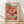 May include: Framed art print featuring Yayoi Kusama's signature polka dot pattern in vibrant colors including coral, pink, orange, mint green, and red circular shapes with various textures and patterns. The poster displays "YAYOI KUSAMA" in bold black letters at top with Japanese characters, dated 1981, and gallery exhibition text at bottom. Shown in thin wooden frame leaning against white wall on light wooden floor with soft natural lighting creating gentle shadows.