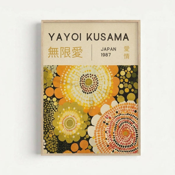 Framed poster featuring abstract polka dot pattern in warm tones of yellow, orange, green, and cream against dark background. The design shows large circular motifs with radiating dots creating flower-like forms. Text at top reads "YAYOI KUSAMA" with Japanese characters and "JAPAN 1987". Light wood frame mounted on white wall with subtle shadow.