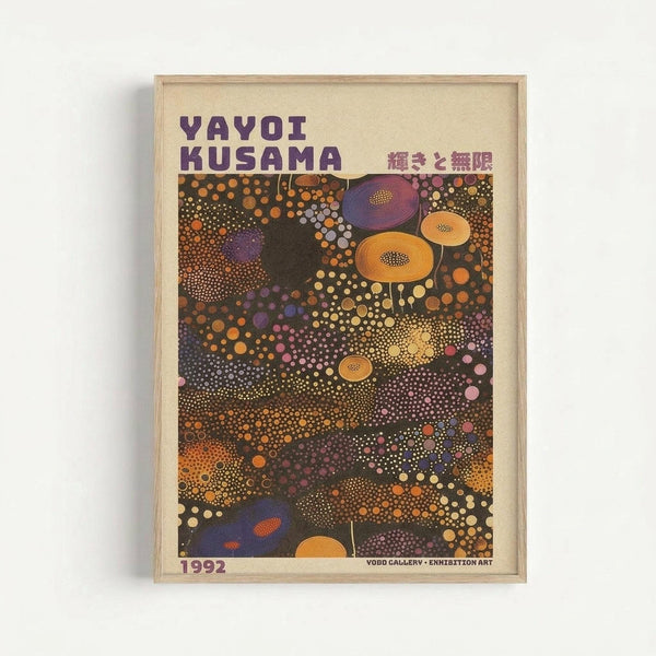 Framed exhibition poster featuring Yayoi Kusama's signature polka dot art in vibrant colors. The artwork displays organic shapes and circular patterns in orange, purple, yellow, and pink against a dark background. Japanese text appears alongside the artist's name at the top, with "1992" and gallery information at the bottom. The poster is displayed in a light wooden frame against a white wall, casting a subtle shadow.