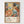 Framed poster featuring vibrant abstract floral artwork with large orange and yellow blooms, polka-dotted patterns in blue and teal, and colorful organic shapes against a cream background. Below the artwork is text reading "YAYOI KUSAMA" with "JAPAN 1987" and Japanese characters, along with red geometric symbols. The poster is displayed in a natural wood frame against a white wall.