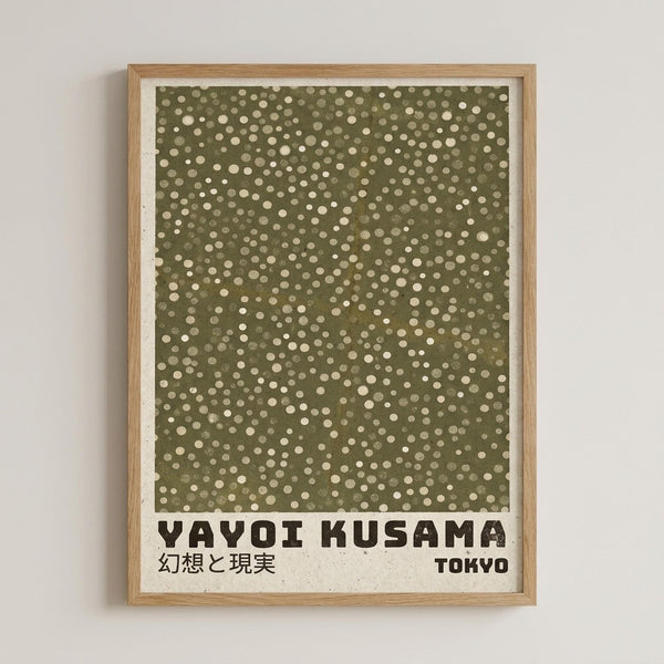 May include: Framed art print with olive green background covered in scattered cream and beige polka dots of varying sizes, displayed in light wood frame against white wall. Print features black text reading "YAYOI KUSAMA" with Japanese characters and "TOKYO" below the dotted pattern on cream colored paper with slightly weathered edges.