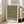May include: Framed art print with olive green background covered in scattered cream and white polka dots of varying sizes, displayed in light wood frame leaning against white wall next to beige upholstered sofa. Print features black text reading "YAYOI KUSAMA" with Japanese characters and "TOKYO" below the dotted pattern. Bright natural light streams through tall windows in minimalist living room setting.