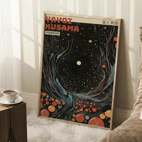 May include: Framed poster with abstract cosmic design featuring swirling flowing lines, colorful dots and circles in orange, red, blue tones against dark background, displayed leaning against white wall corner next to wooden side table with coffee cup, on textured cream rug beside beige furniture in bright natural lighting