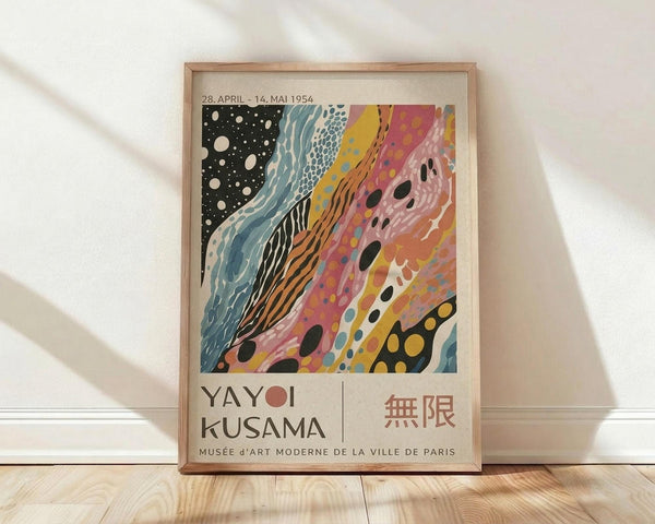 May include: Framed vintage-style exhibition poster with abstract flowing design in black, teal, yellow, pink and orange colors featuring organic shapes and polka dots. Text shows dates "28. APRIL - 14. MAI 1954" and "YAYOI KUSAMA" with Japanese characters and "MUSÉE d'ART MODERNE DE LA VILLE DE PARIS". Natural wood frame sits on light wooden floor against white wall with soft shadows.