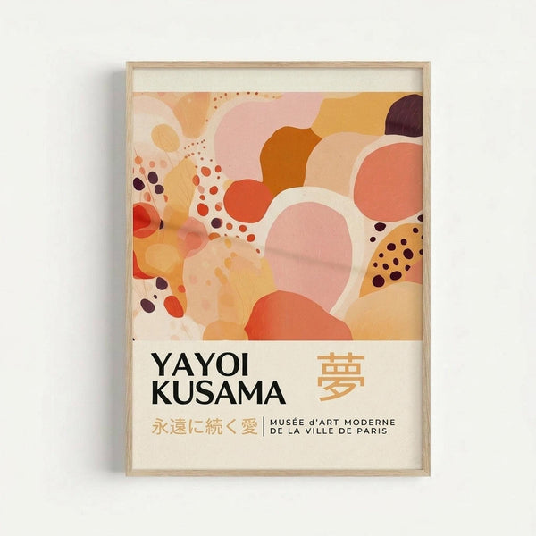 Framed abstract art print featuring organic flowing shapes in warm tones of coral, orange, pink, peach, and burgundy with scattered dots throughout. The artwork has a dreamy, fluid composition with overlapping curved forms. Below the colorful design is text reading "YAYOI KUSAMA" with Japanese characters and "永遠に続く愛 | MUSÉE d'ART MODERNE DE LA VILLE DE PARIS" on a cream background. The print is displayed in a light wood frame against a white wall.
