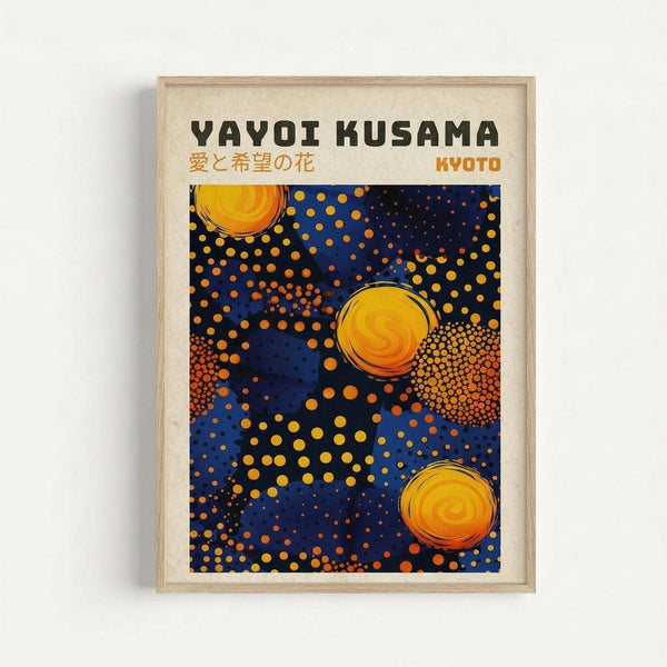 Framed poster with Yayoi Kusama's name at top in black letters, Japanese text below, and "KYOTO" in orange. The artwork features a deep blue background with golden yellow and orange polka dots of varying sizes scattered throughout. Three large circular forms with swirling orange and yellow gradients are positioned across the composition. The print is displayed in a light wooden frame against a white wall.