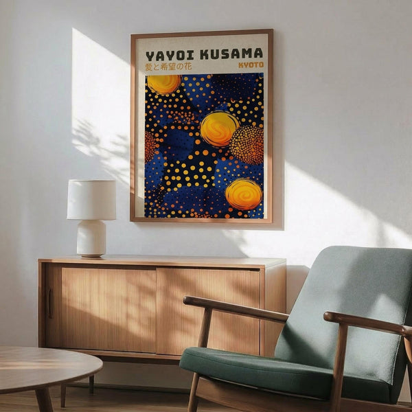 May include: Framed art print with blue background featuring yellow and orange polka dots and circular sun-like designs, displayed above a wooden credenza with white ceramic lamp in a mid-century modern living room setting with mint green upholstered chair and round coffee table