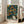 May include: Framed poster with abstract polka dot design in dark green background featuring colorful circles in yellow, orange, red, and blue with flowing curved lines, displayed on white wall next to beige sofa in bright living room with large windows and natural lighting
