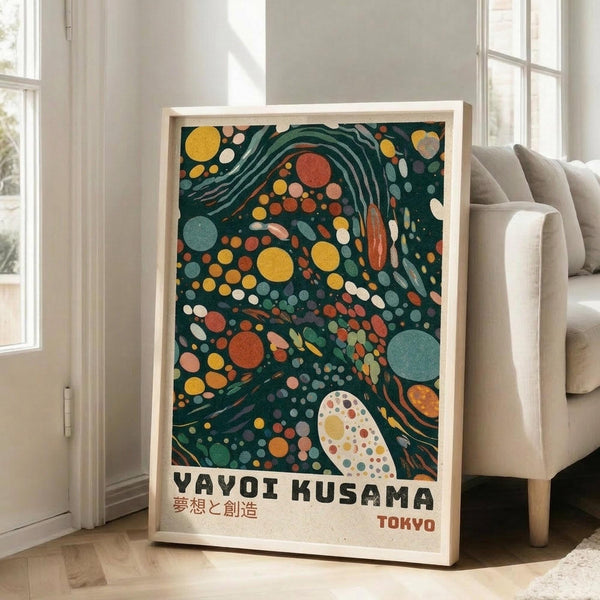 May include: Framed poster with abstract polka dot design in dark green background featuring colorful circles in yellow, orange, red, and blue with flowing curved lines, displayed on white wall next to beige sofa in bright living room with large windows and natural lighting