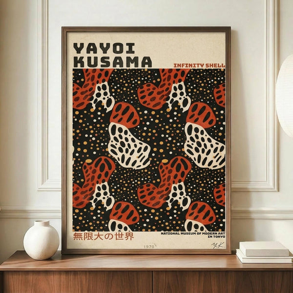 May include: Framed vintage-style exhibition poster with black background featuring repeating pattern of red and white polka-dotted organic shapes resembling shells or pumpkins scattered with small yellow and white dots. Text reads "YAYOI KUSAMA" and "INFINITY SHELL" with Japanese characters and museum details. Brown wooden frame displayed on walnut credenza beside white ceramic vase and stacked books in elegant room with cream walls and white trim.