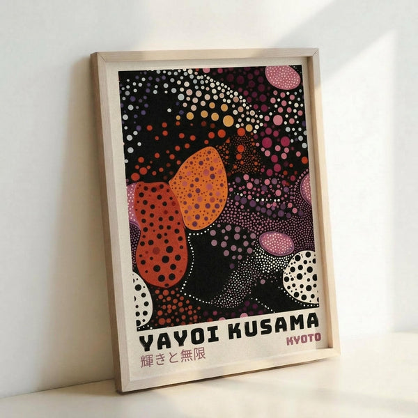 May include: Framed poster print with vibrant polka dot artwork in orange, pink, purple, and white circles on black background, displayed in light wood frame leaning against white wall. The colorful dotted pattern creates flowing organic shapes with Japanese text at bottom.