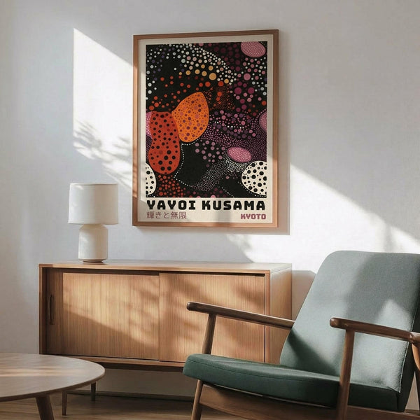 May include: Framed poster with abstract polka dot artwork in orange, pink, purple, and white circles on dark background, displayed above wooden sideboard with white table lamp in modern living room setting with mint green armchair and round coffee table