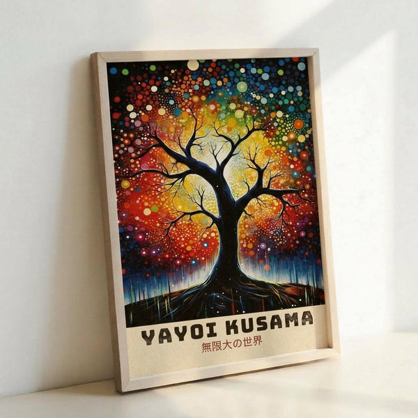Framed art print featuring a large tree with sprawling black branches against a vibrant cosmic background filled with colorful dots and circles in rainbow hues of red, orange, yellow, green, blue, and purple. The tree has visible roots and sits on dark ground with a starry, dotted sky surrounding it. Japanese text appears below the artwork. The print is displayed in a light wooden frame leaning against a white wall.