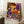 May include: Framed poster featuring vibrant dotted artwork in purple, orange, black and white with circular patterns and polka dots in Kusama's signature style. Text reads "Yayoi Kusama" with Japanese characters and "Kyoto" below. Frame leans against white wall next to coffee cup on wooden surface and beige fabric, showing scale and home decor context.
