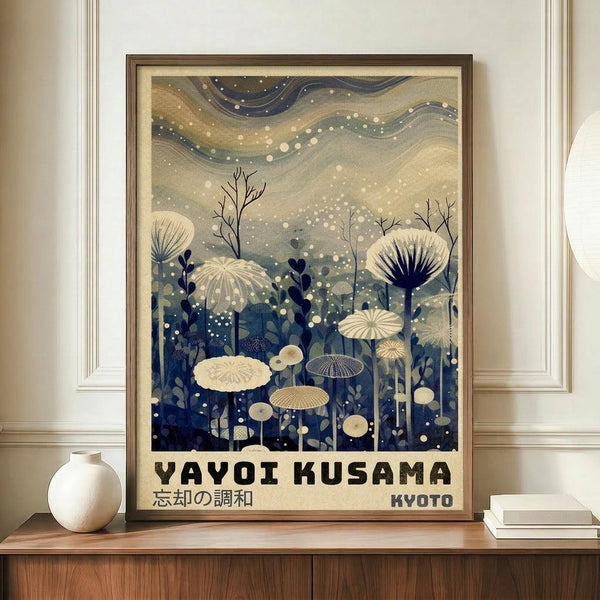 May include: Framed art print displayed on wooden sideboard next to white ceramic vase and stacked books. The poster features cream and blue tones with flowing wavy sky, white dots throughout, and silhouettes of mushrooms and botanical elements in foreground. Text reads "YAYOI KUSAMA" and "KYOTO" at bottom with Japanese characters. Soft natural lighting in elegant room setting with white walls and crown molding.